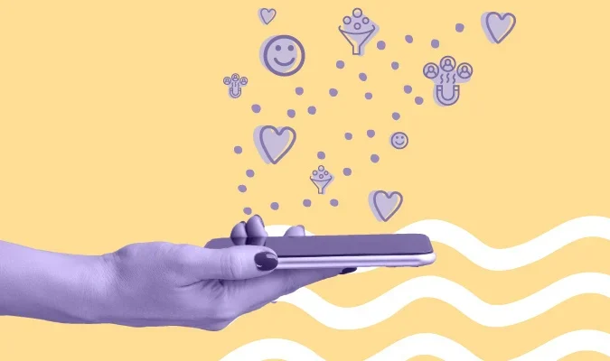 Uma mão segura um smartphone, de onde saem diversos ícones sociais.