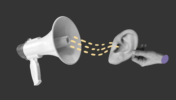 Um megafone enviando uma mensagem para uma orelha.