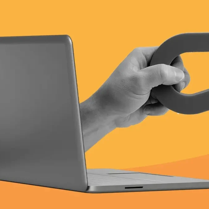 Ilustração de uma mão segurando um ímã, saindo da tela de um computador