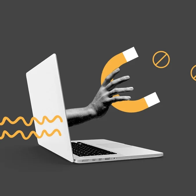 Fotomontagem de uma mão saindo da tela de um laptop e segurando um ímã, para ilustrar artigo sobre como problemas técnicos de um site atrapalham o tráfego orgânico e a aquisição de novos negócios.